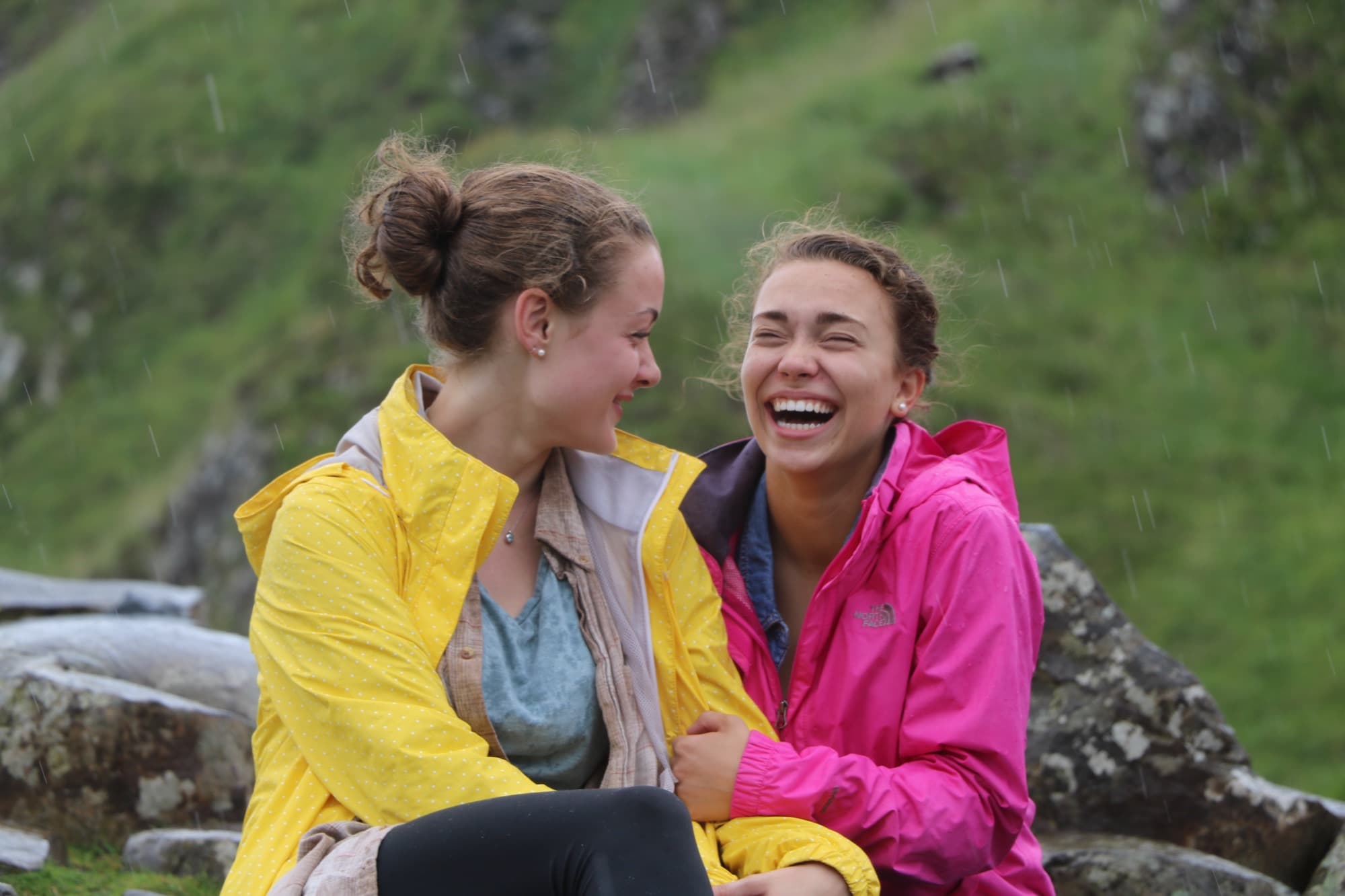 Two students laughing in the Irish rain